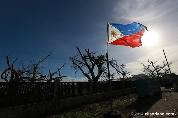 A Philippine flag stands amid the Yolanda-devastated Tacloban City, symbolizing the hope that still remains among the affected Filipino families (File photo: Rovic Balunsay, Photoville International)