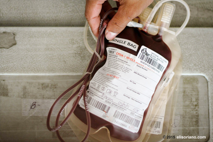 A blood bag is held by a staff of the Philippine Blood Center during the Mass Blood Donation Drive of the Members Church of God International (MCGI) in March 2015. 